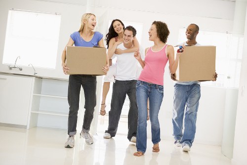 Removalists loading household furniture in Richmond street setting