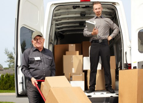 Team member loading boxes safely into a van