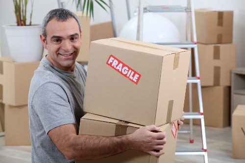 Professional movers carrying household items through a Richmond property