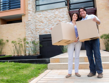 Movers handling furniture in a Richmond residential street